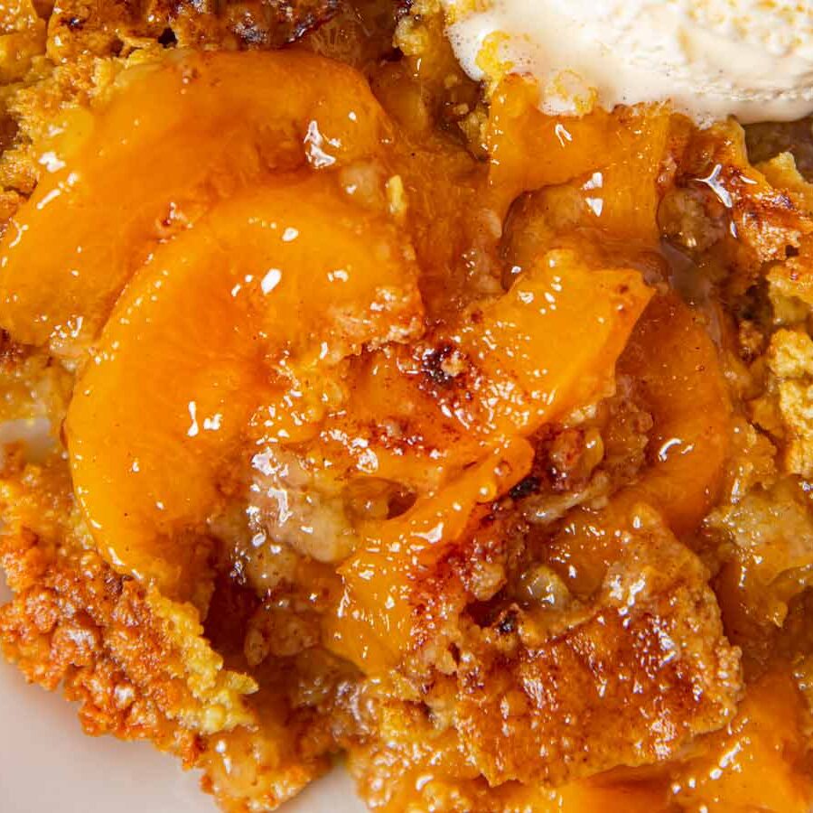 Peach Crisp serving on plate with vanilla ice cream