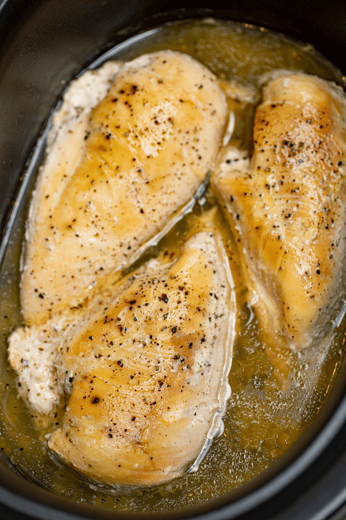 Cooked and seasoned chicken in a crockpot