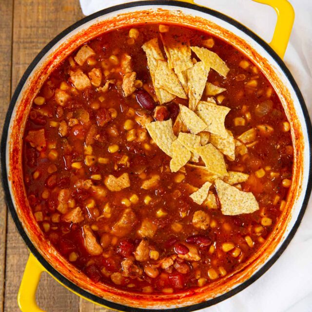 Chicken Taco Soup in bowl with tortilla chip garnish