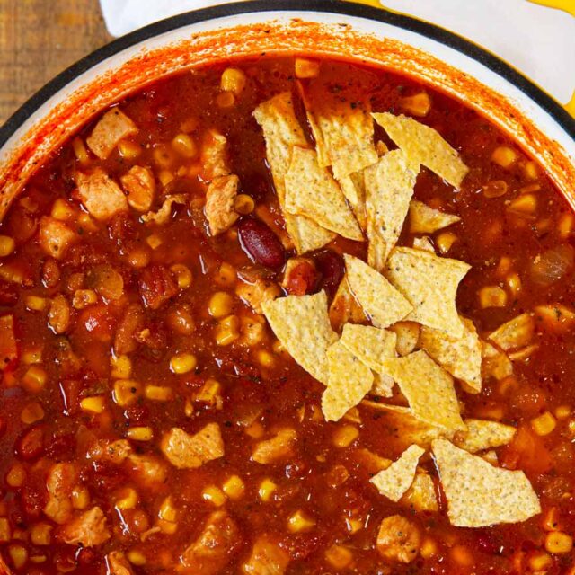 Chicken Taco Soup in bowl with tortilla chip garnish