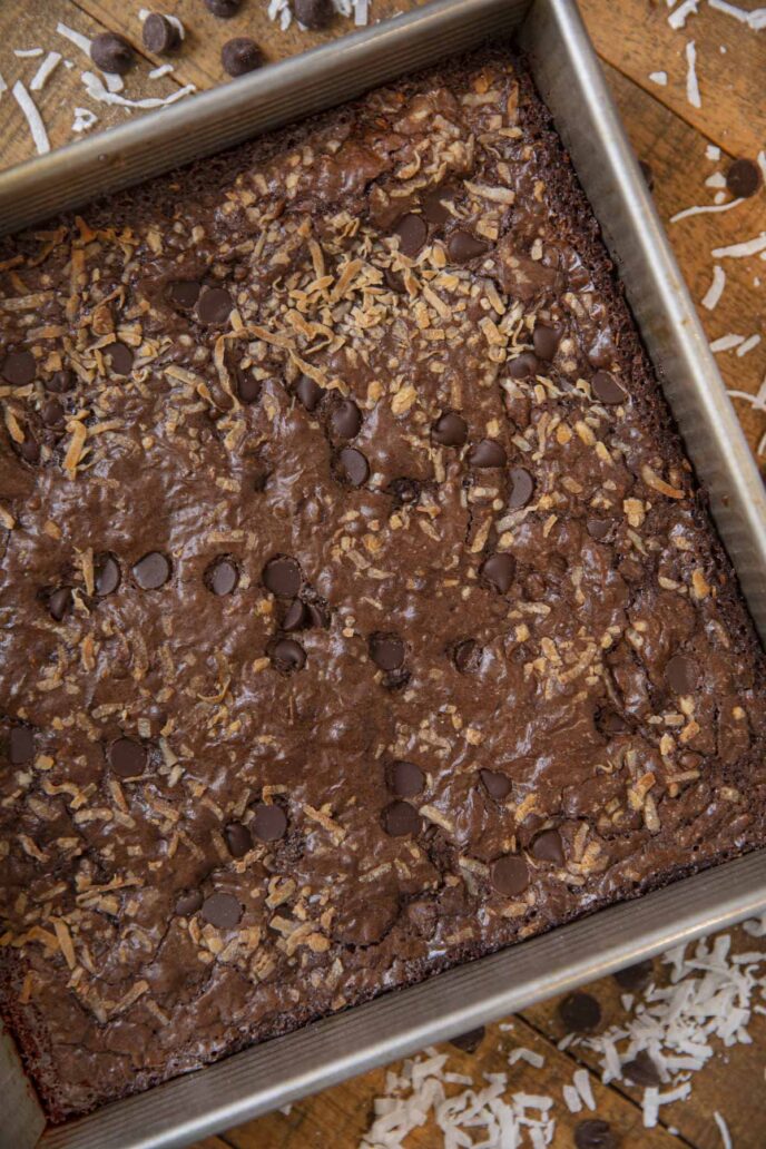 Toasted Coconut and Chocolate Chip Brownies in baking pan on wooden table