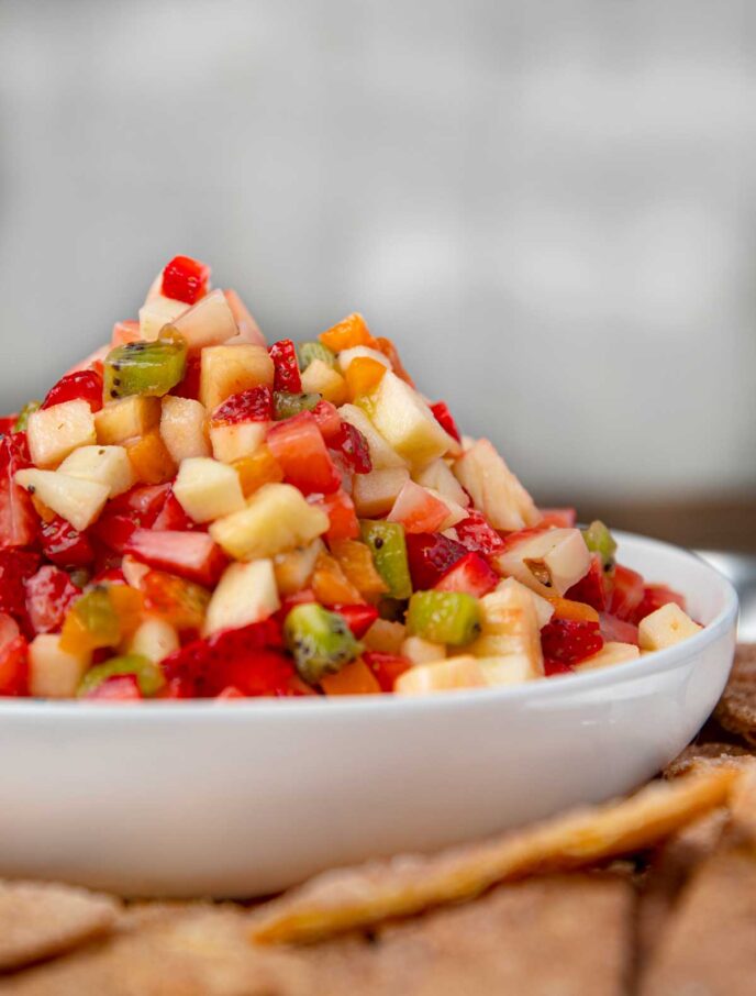Fruit Salsa with apples, strawberries, tangerines, pineapple and kiwi in bowl