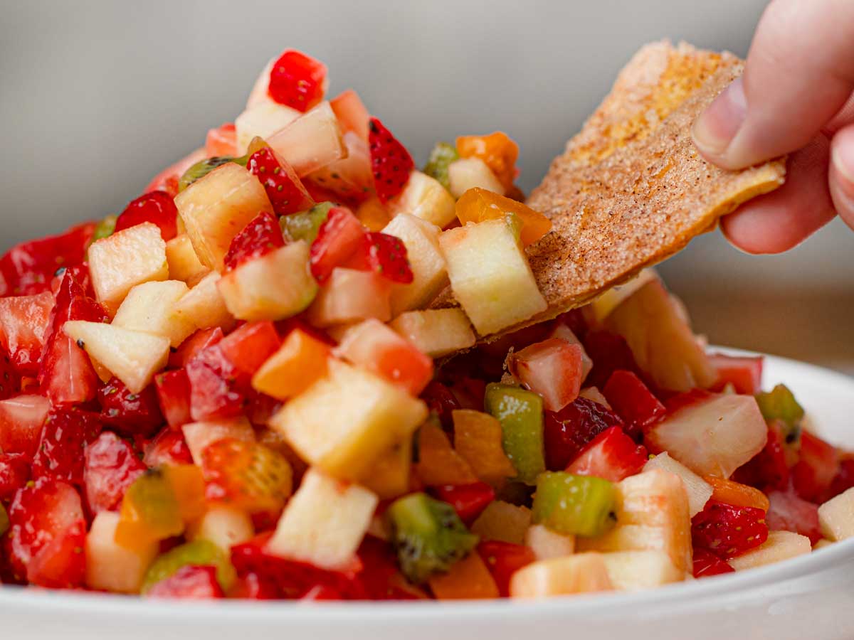 Fruit Salsa in bowl with cinnamon chip dipping