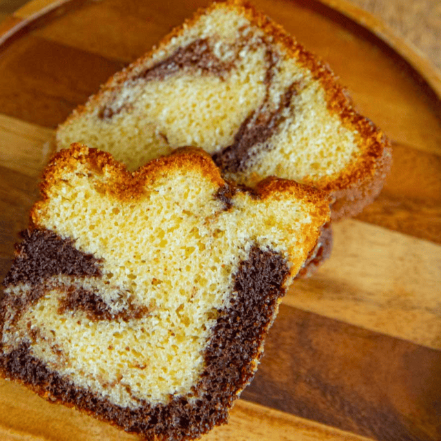 two slices of cake on a wooden tray