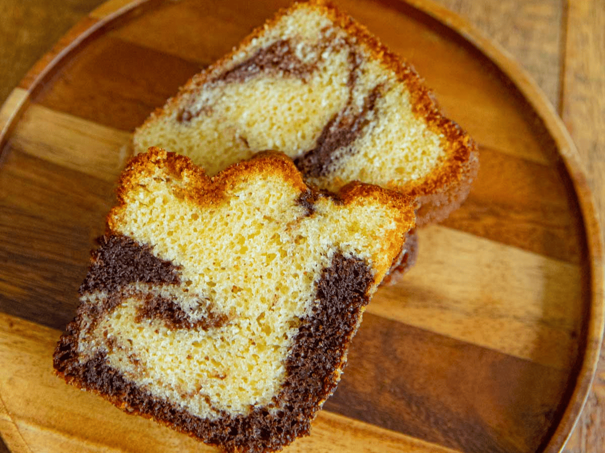 two slices of cake on a wooden tray