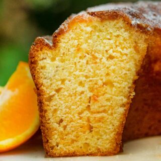 Orange Bundt Cake on cake stand, sliced