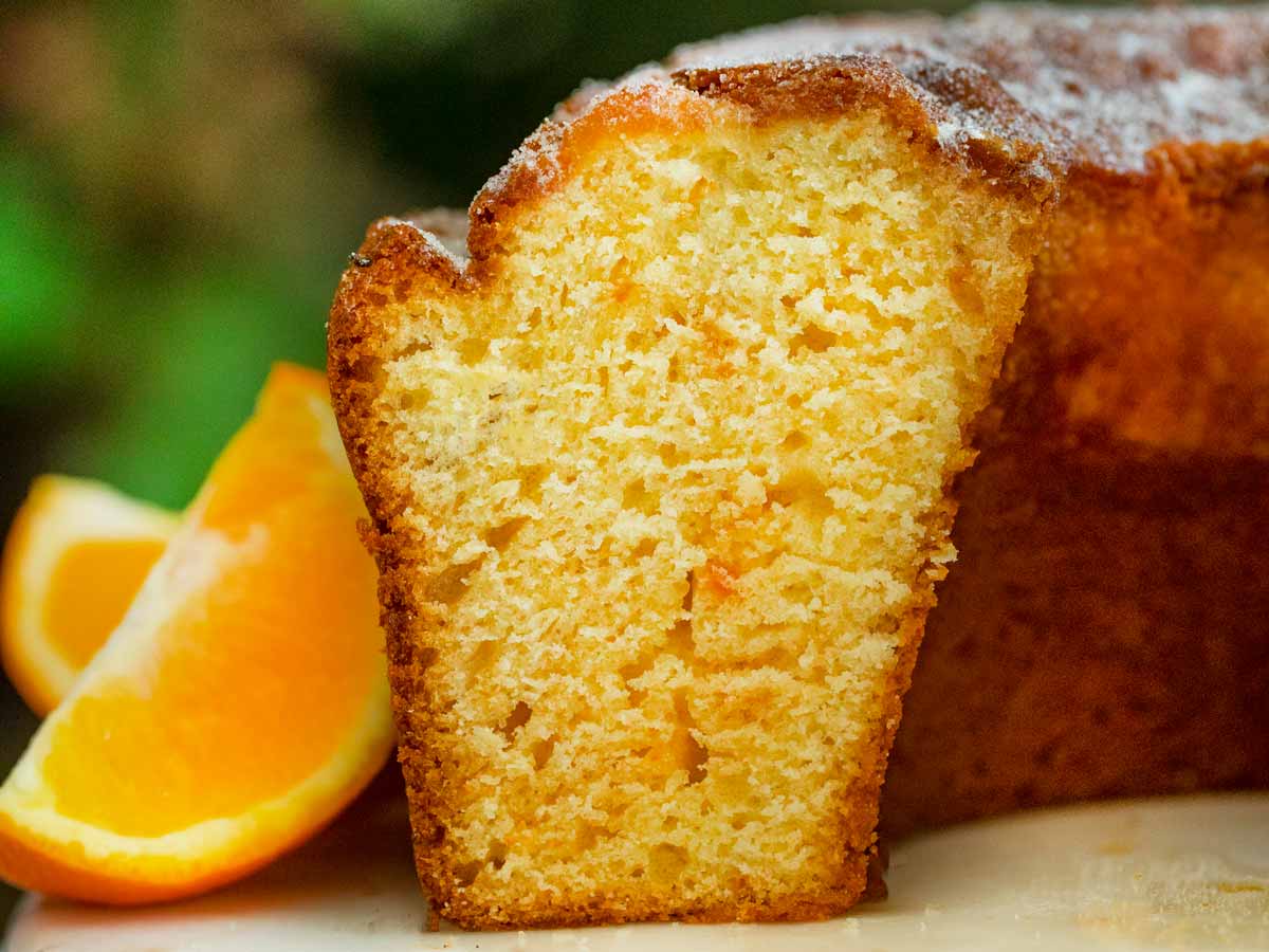 Orange Bundt Cake on cake stand, sliced