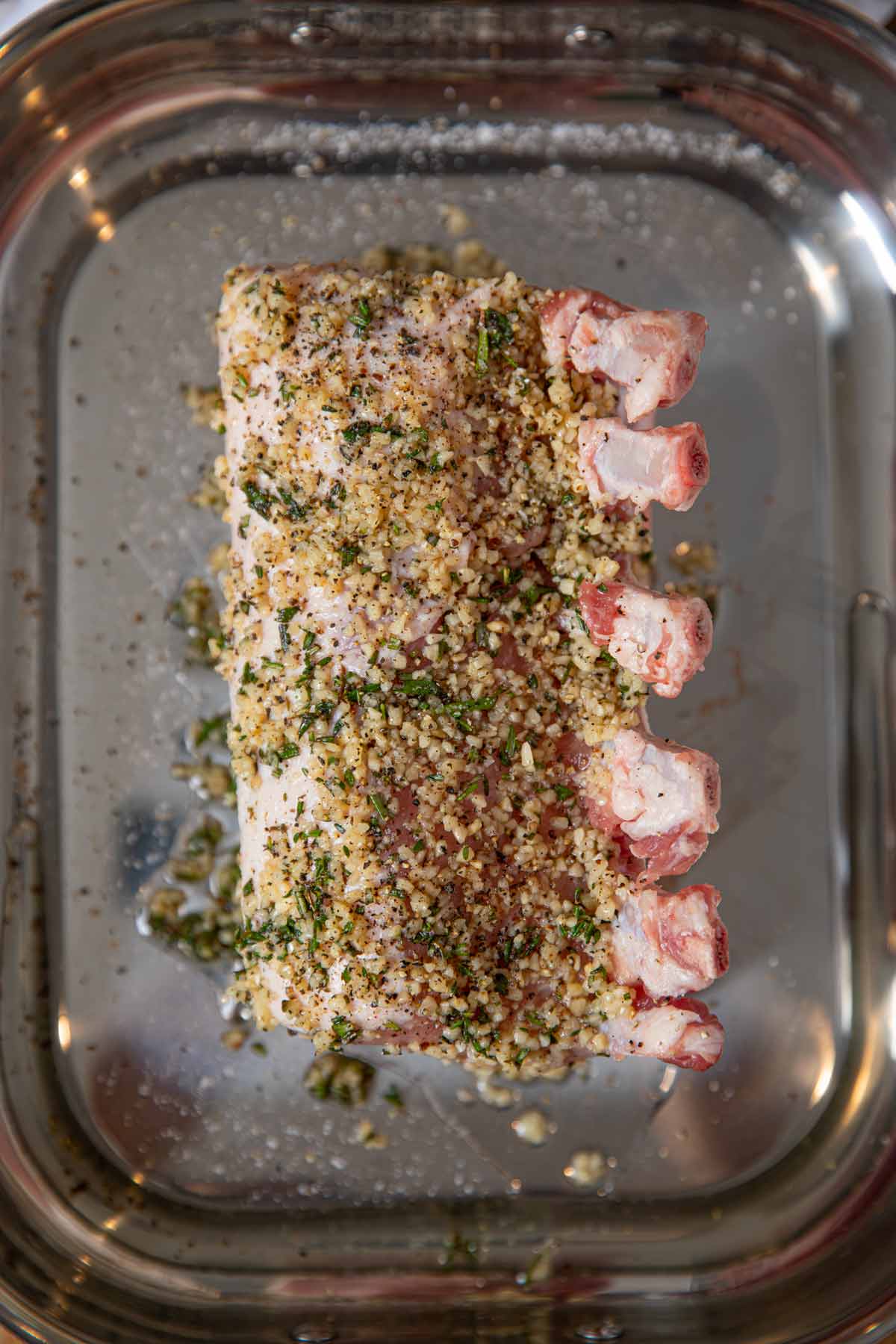 Roasted Rack of Pork on roasting pan before cooking