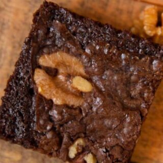 A brownie showing a walnut in the center.