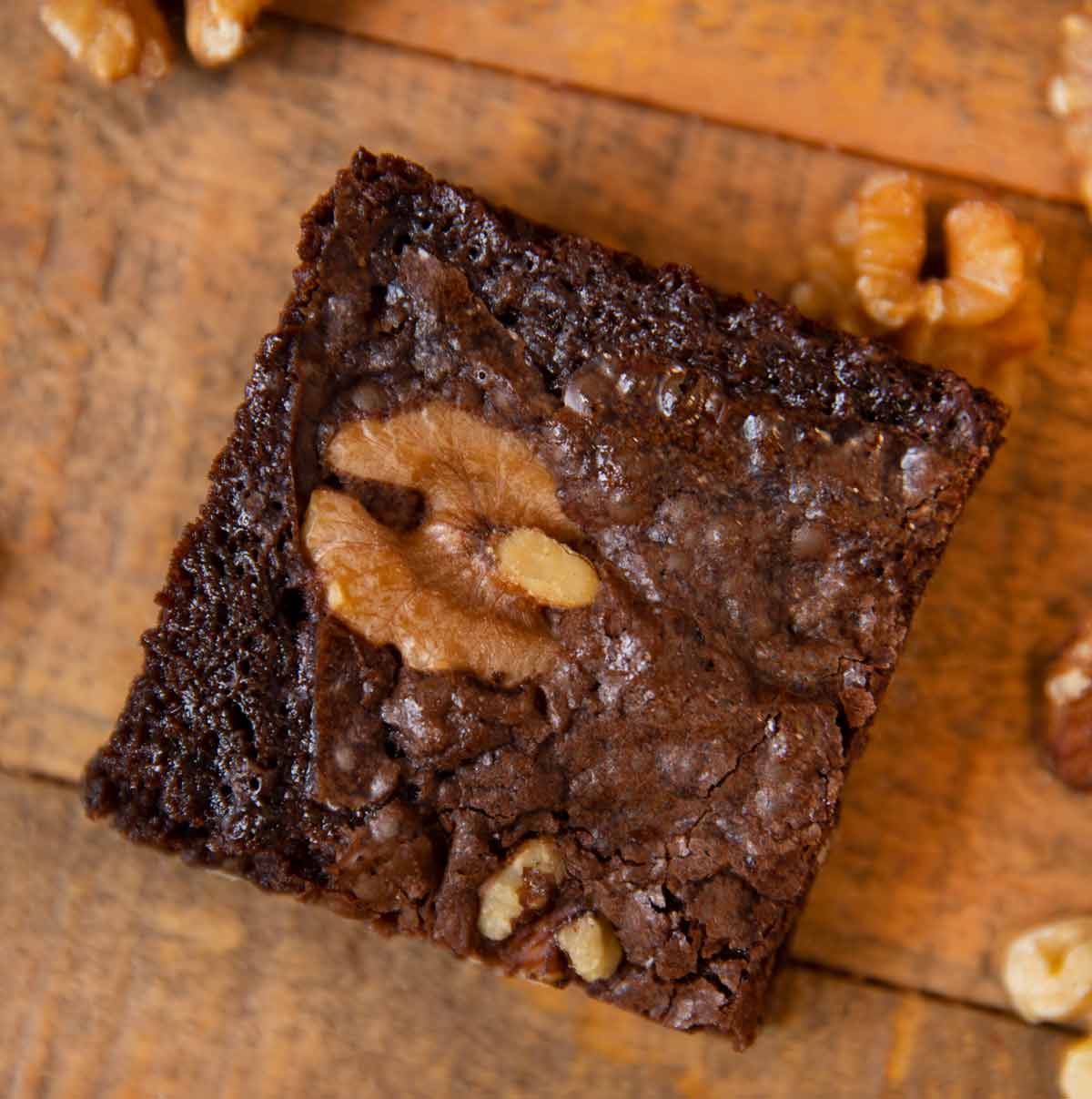 Walnut Brownies single brownie on cutting board, top-down view