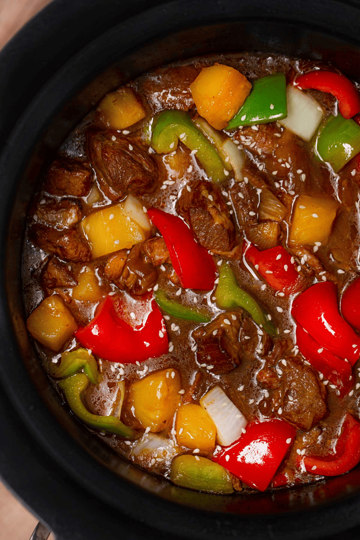 Crockpot with pork, vegetables, pineapple, and sauce