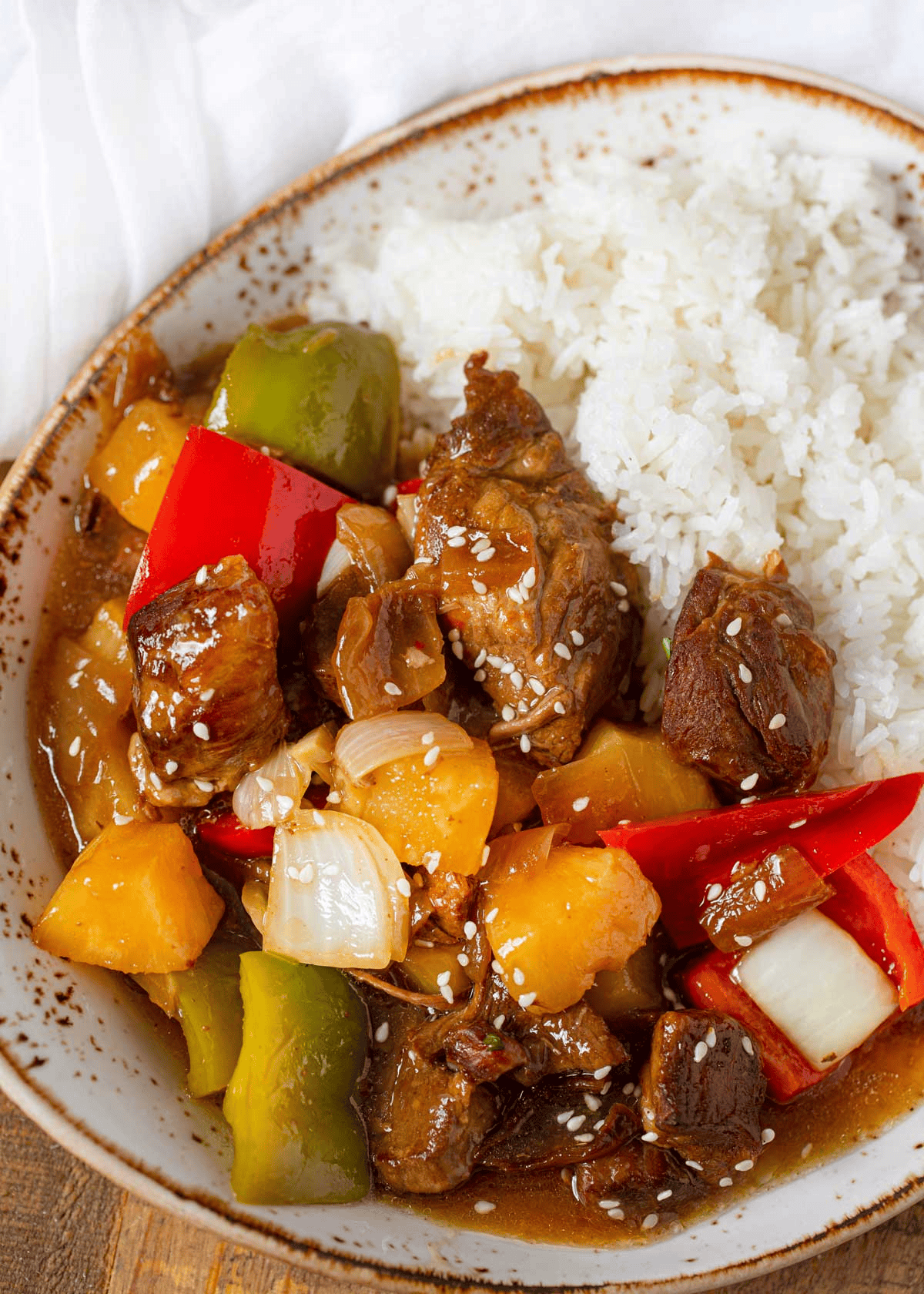 Finished sweet and sour pork topped with sesame seeds
