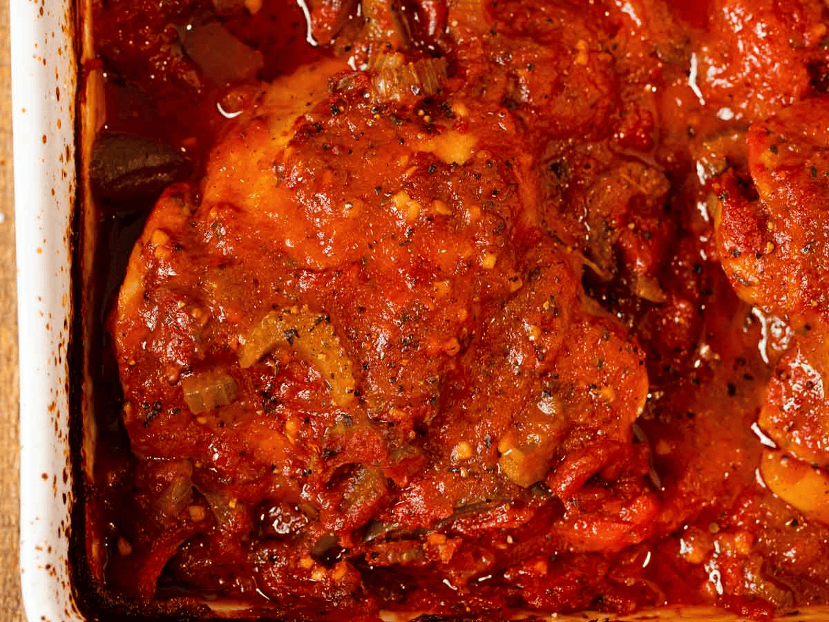 Close up of baked chicken smothered in red sauce