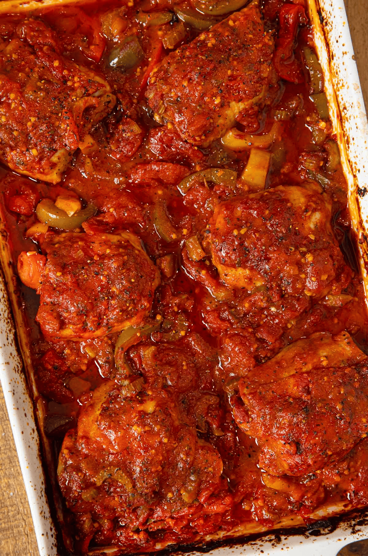 Pan of chicken thighs, vegetables, and red sauce