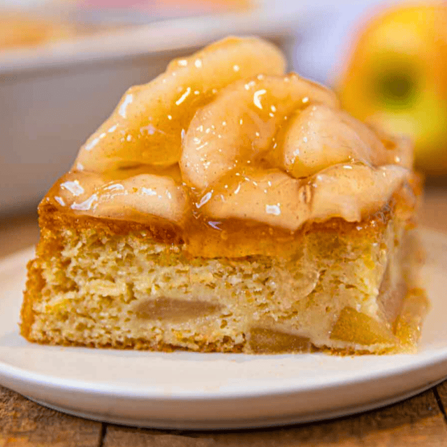 square loaf topped with tart fruit in glaze on top of a plate