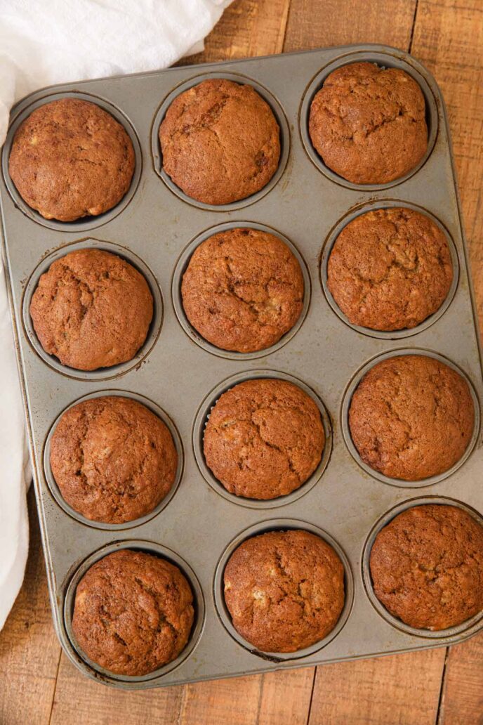 Grey muffin tin with Banana Muffins in it