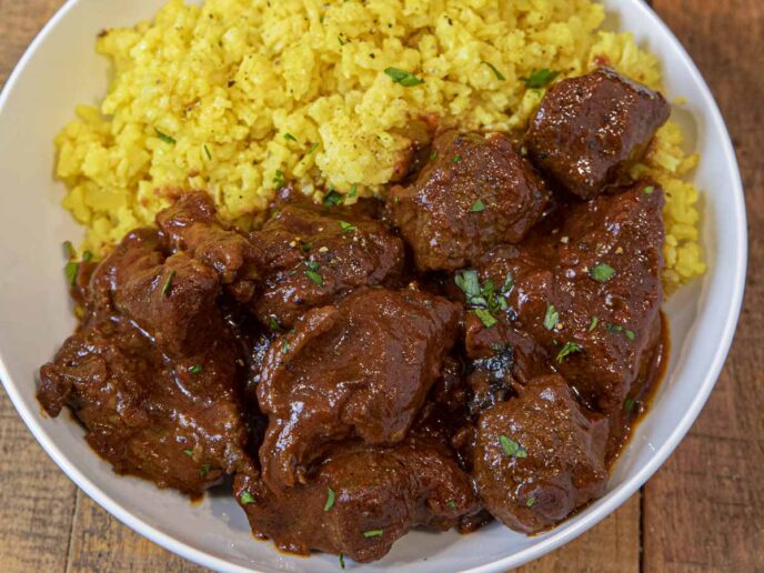 Chile Beef Colorado in bowl with yellow rice