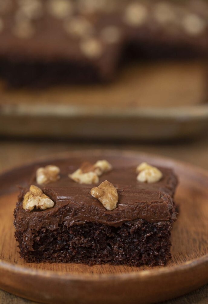 Texas Walnut Chocolate Sheet Cake slice on wooden plate