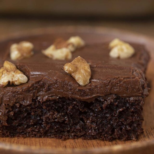 Chocolate Texas Sheet Cake slice on wooden plate