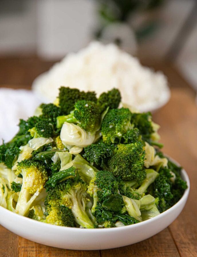 mixed veggies with a bowl of rice in the background