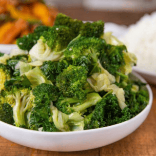 bowl of mixed veggies in a white bowl with other bowls of food in background
