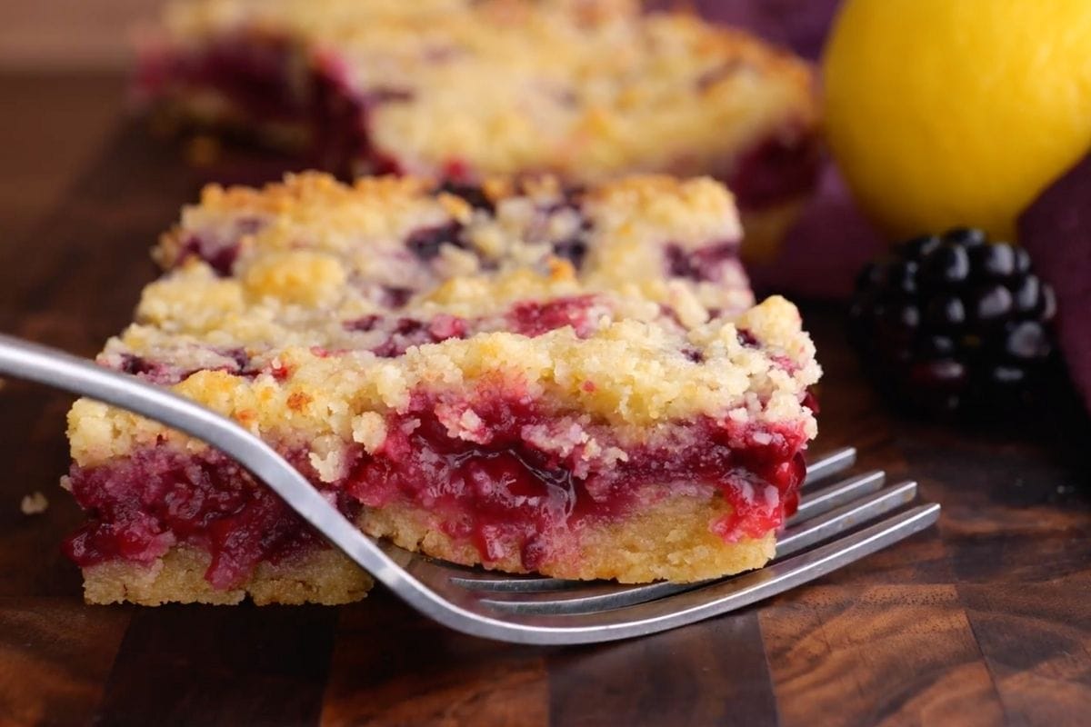 Blackberry Crumb Bars slice on board with fork