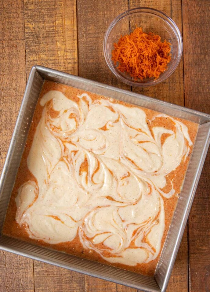 Carrot Cake Cheesecake Bars in baking pan before cooking