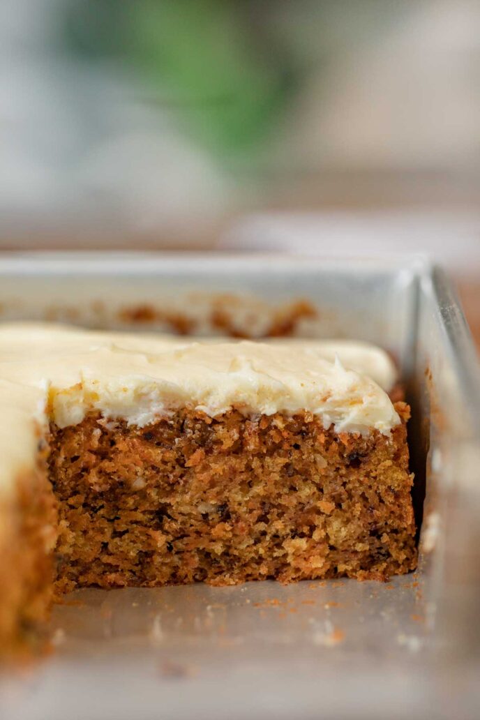 Carrot Sheet Cake in baking pan with slice removed