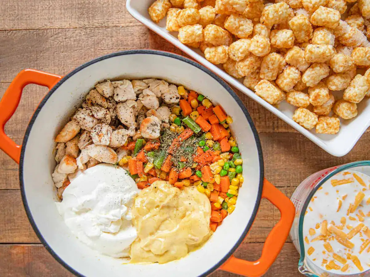 Ingredients for casserole in a pot and frozen tater tots in a pan
