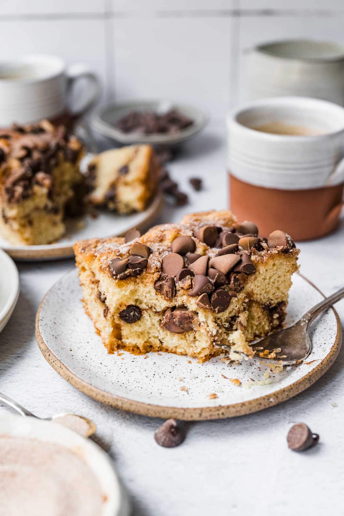 Chocolate Chip Coffee Cake slice on plate with coffee