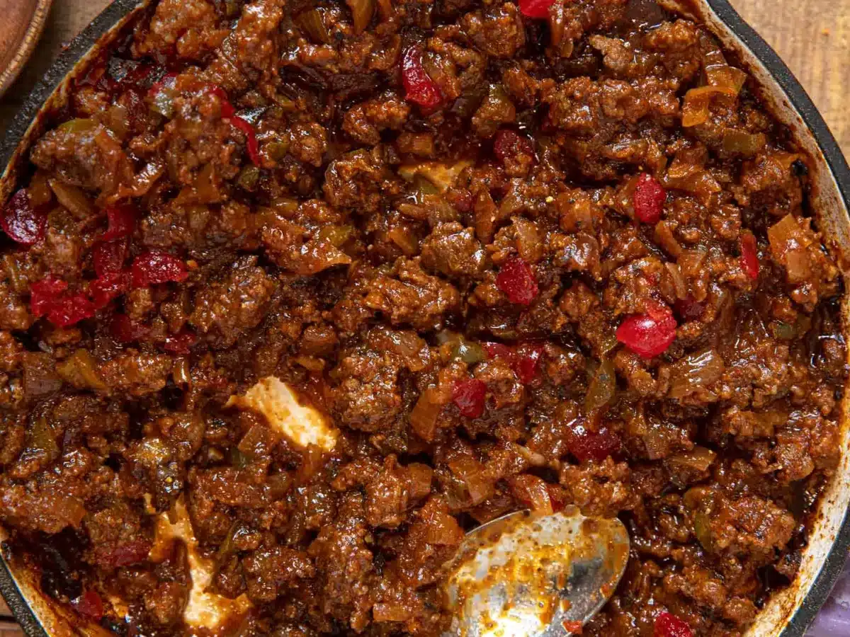 Close up of meat in pan with spoon