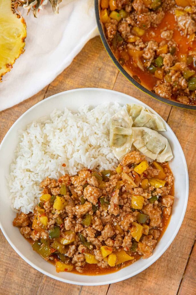 Ground Sweet and Sour Chicken on plate with rice and wontons