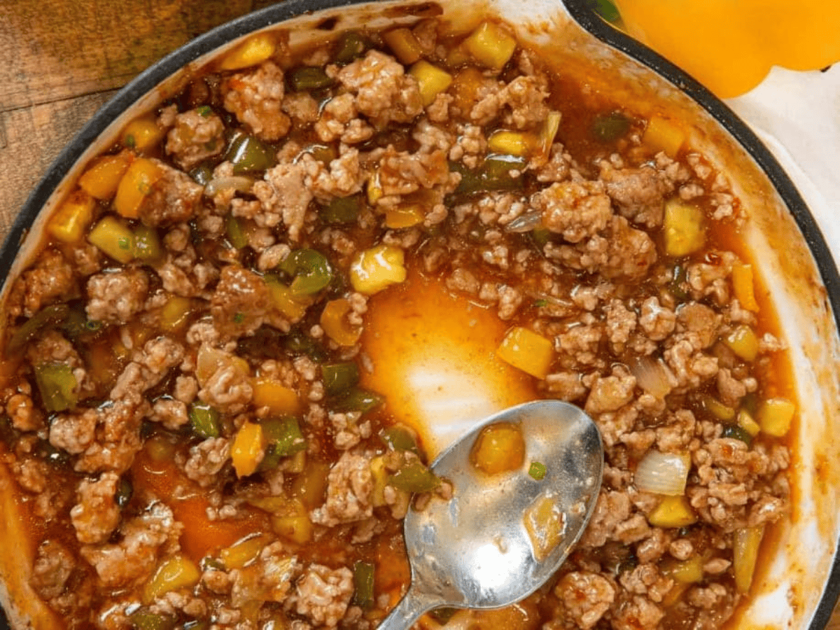 spoon in a pan of ground chicken mixture
