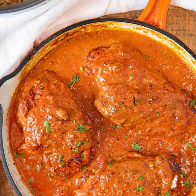 Indian Butter Chicken whole breasts cooked in pan