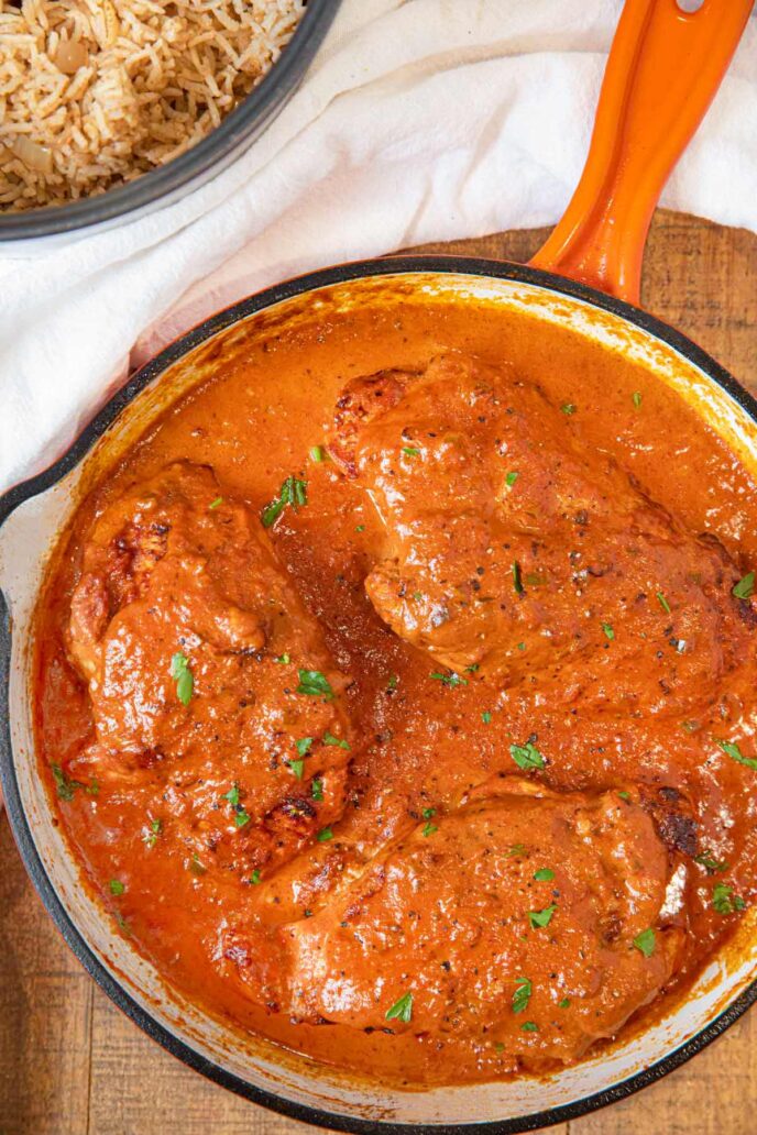 Indian Butter Chicken whole breasts cooked in pan