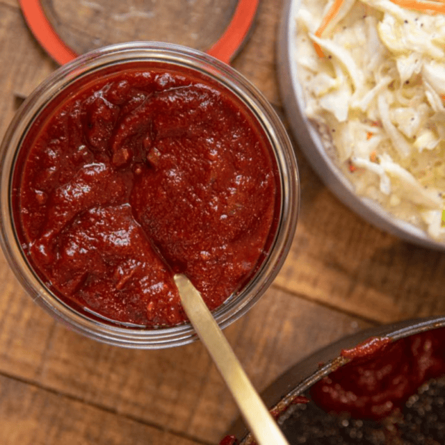 top down view of bbq sauce with slaw on the side