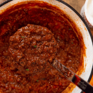 chili in pot with ladle taking scoop out