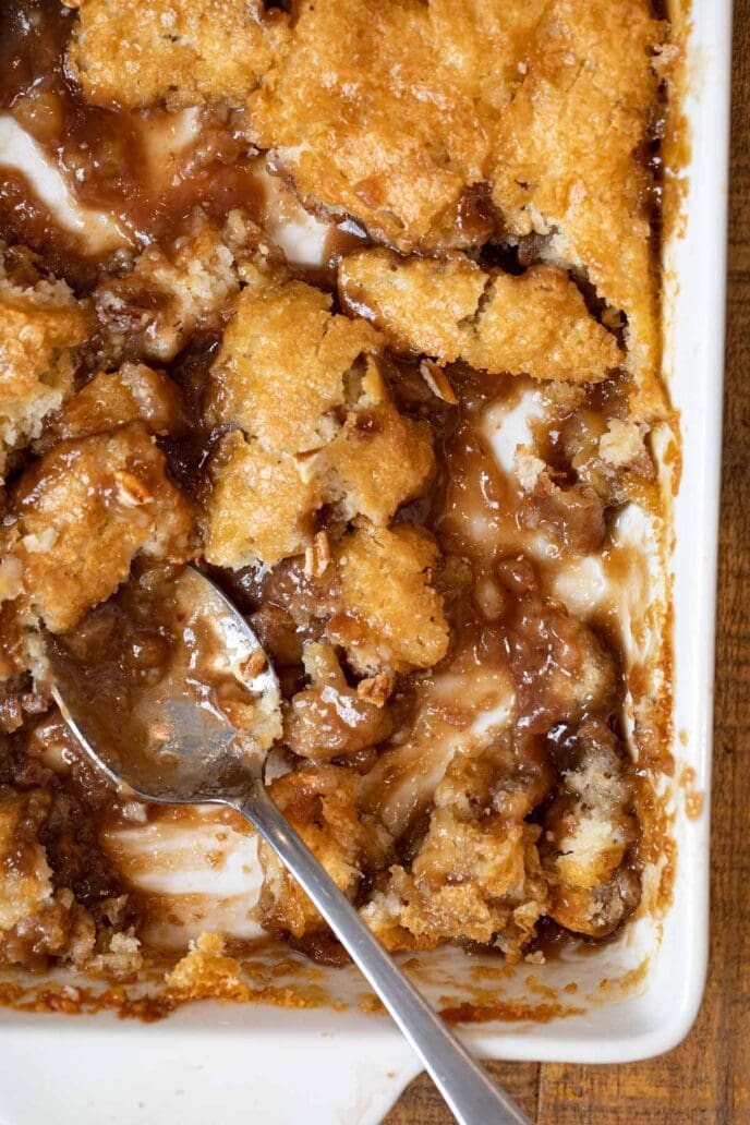 Pecan Cobbler in baking dish with spoon