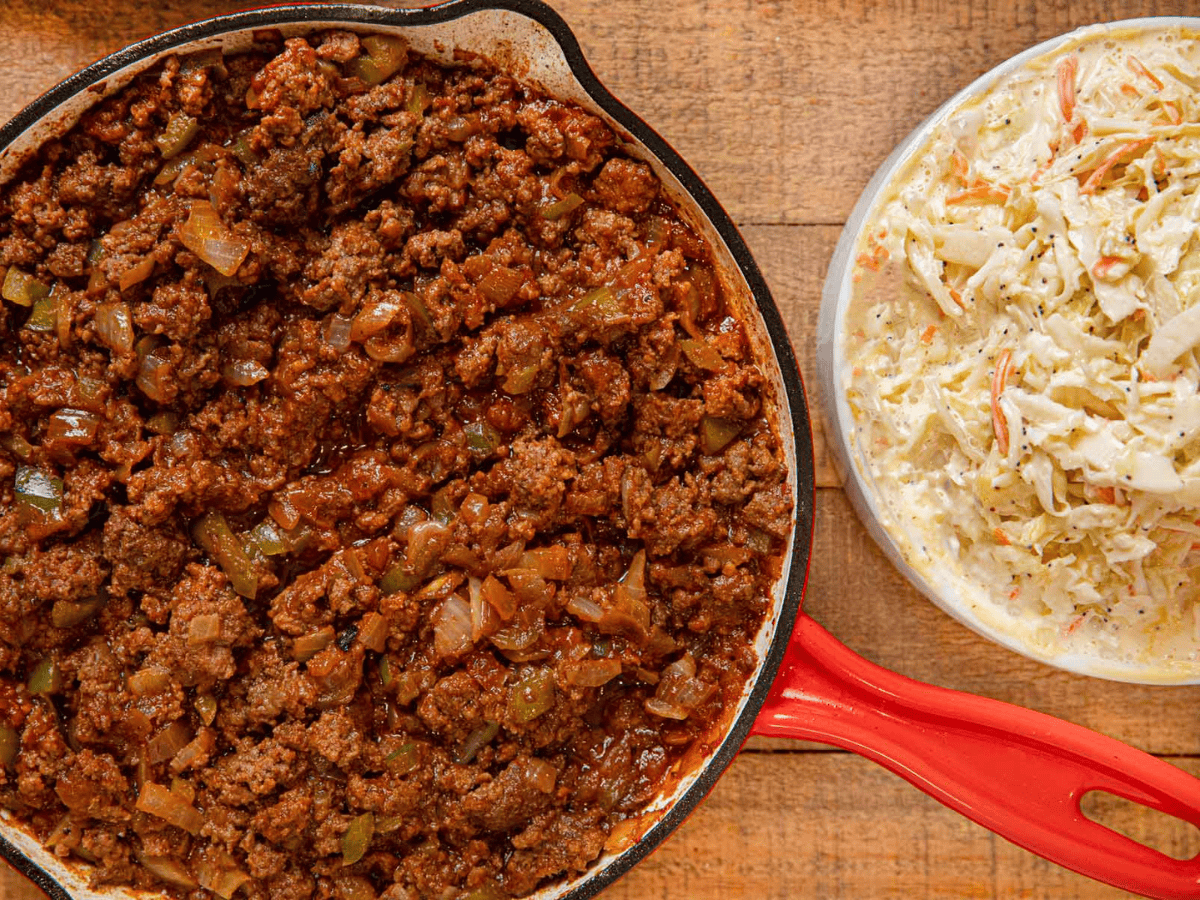 meat in skillet and cole slaw on side