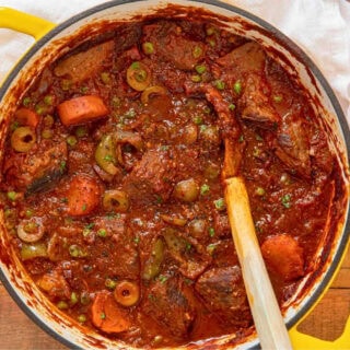 Pot of stew with a wooden spoon