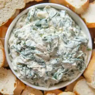 Dip in a serving bowl with slices of bread on the side.