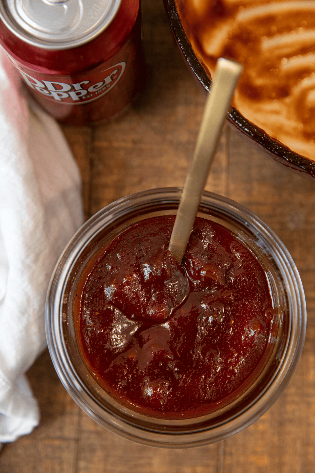 Finished sauce shown in a glass container with a spoon
