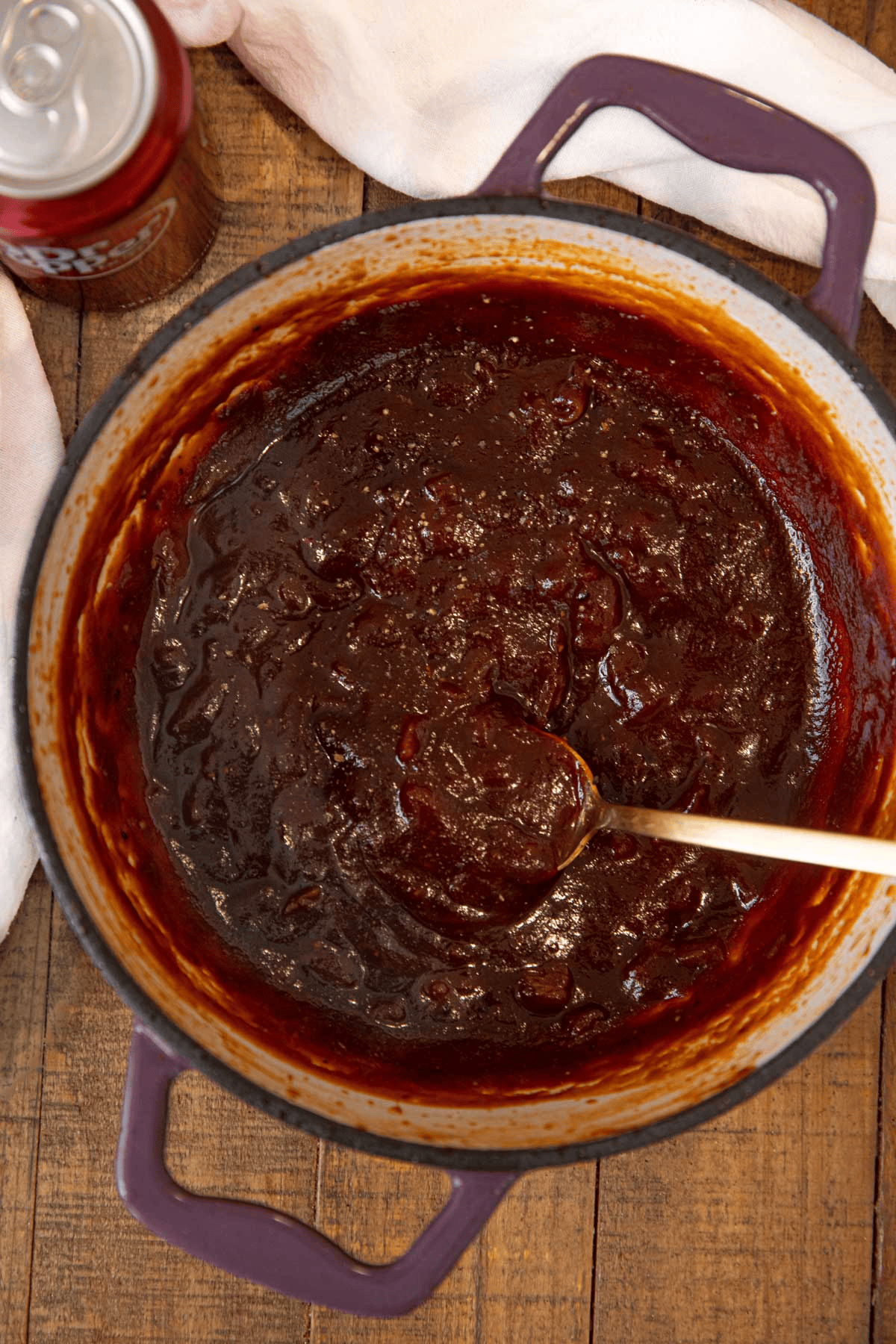 Pot of sauce with a can of soda on the side