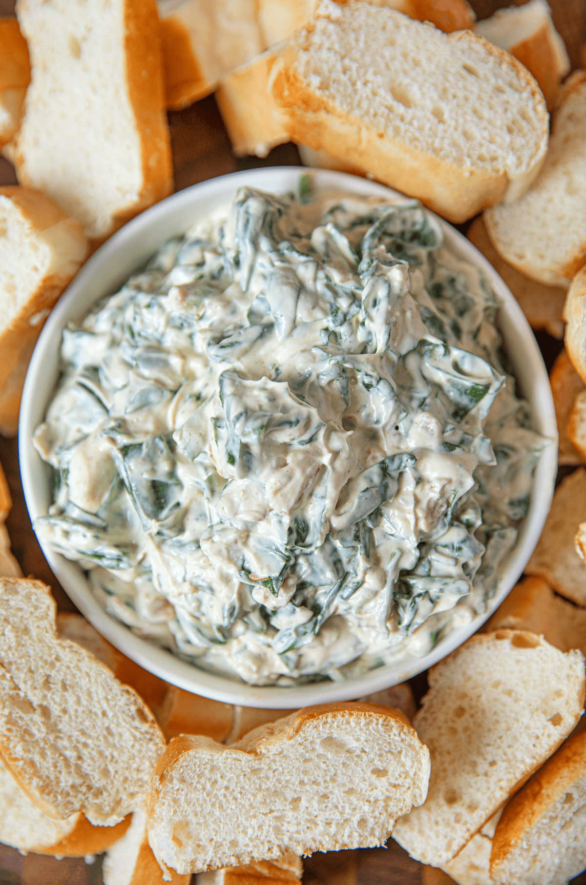 Dip with sliced bread surrounding the bowl