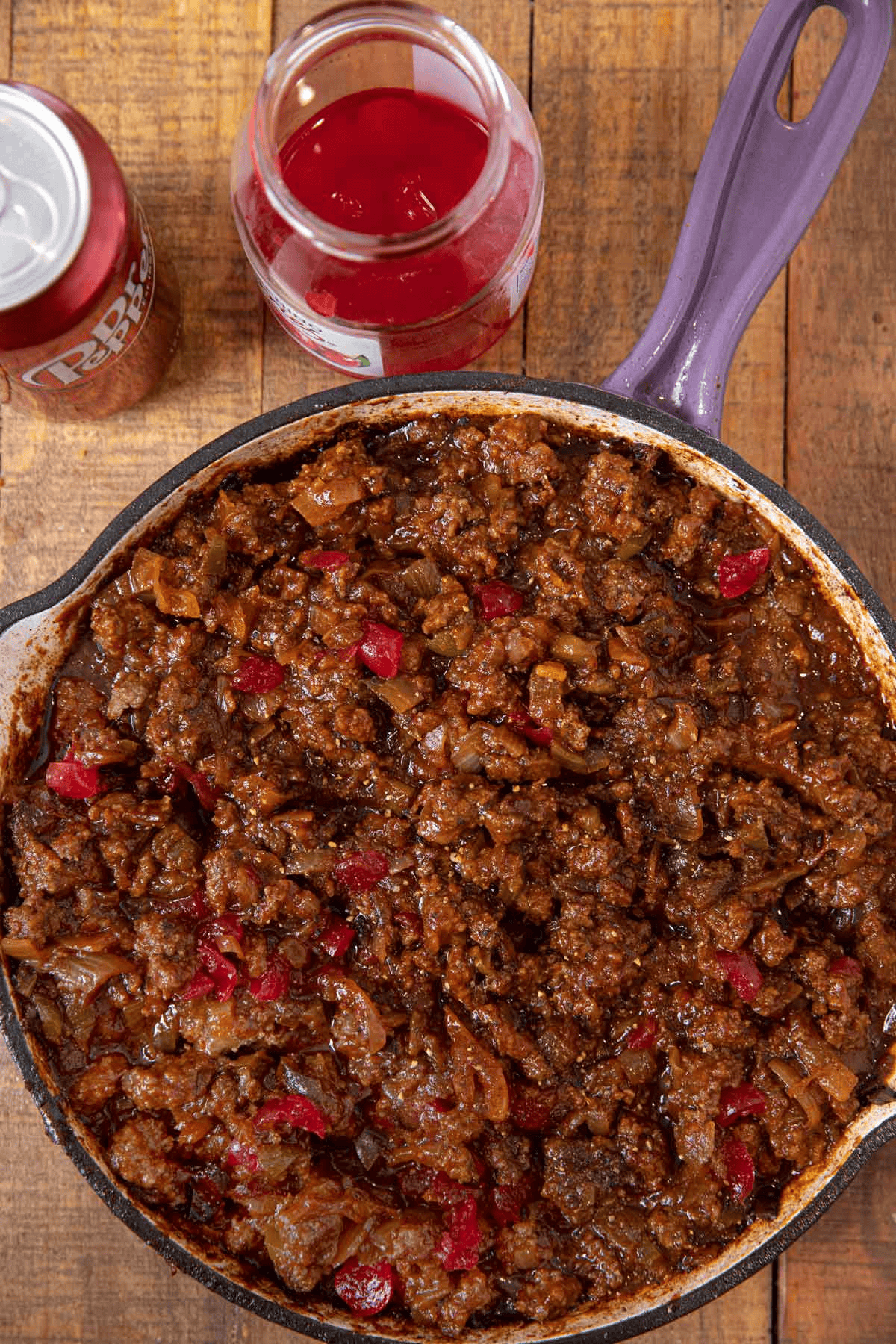 Ground beef mixture with cherries and dr. pepper on the side
