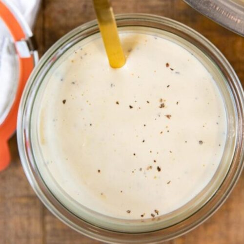Sauce in a glass jar with a spoon