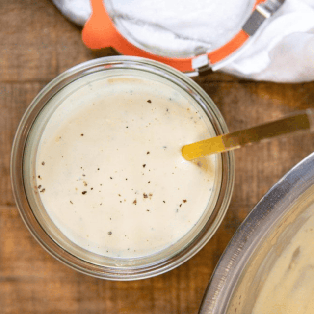jar of sauce with a spoon in it