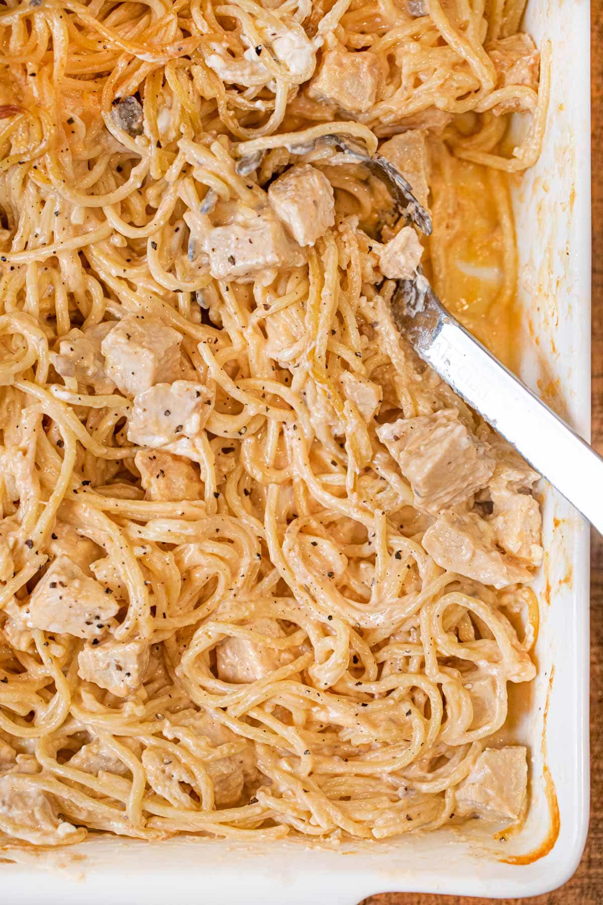 Baked Chicken Spaghetti in baking pan with spoon