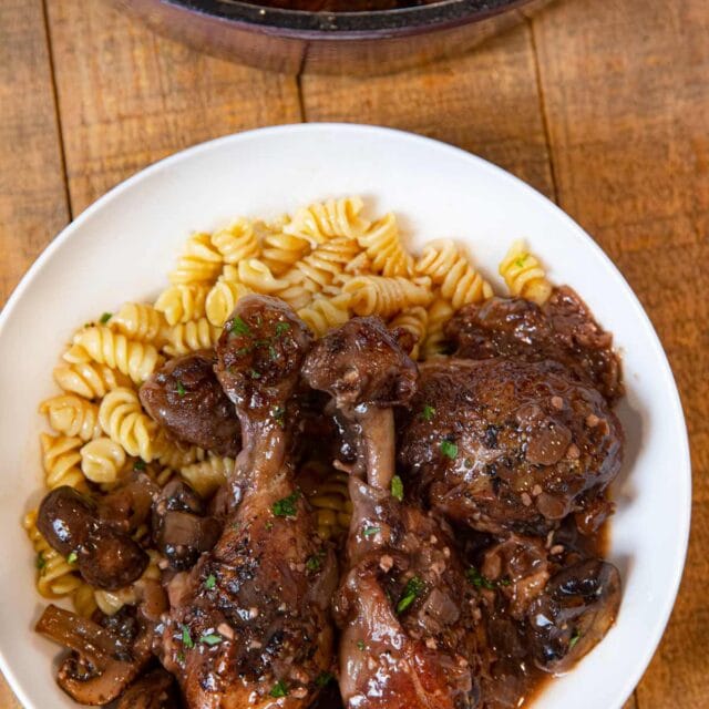 Red Wine Braised Legs with Mushrooms serving on plate with rotini pasta