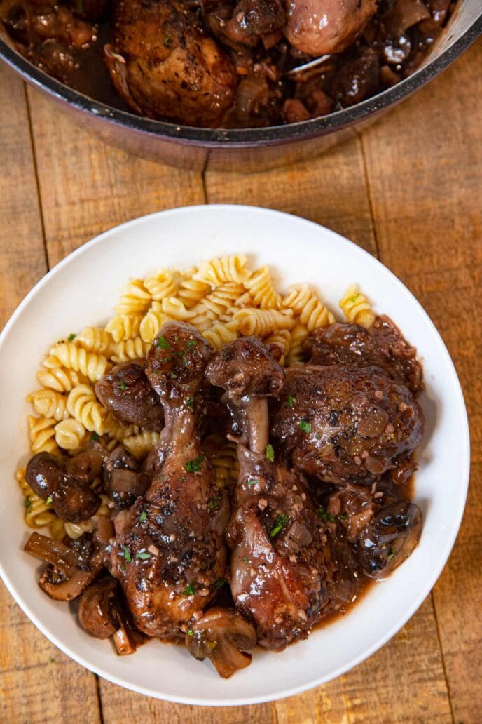 Red Wine Braised Legs with Mushrooms serving on plate with rotini pasta